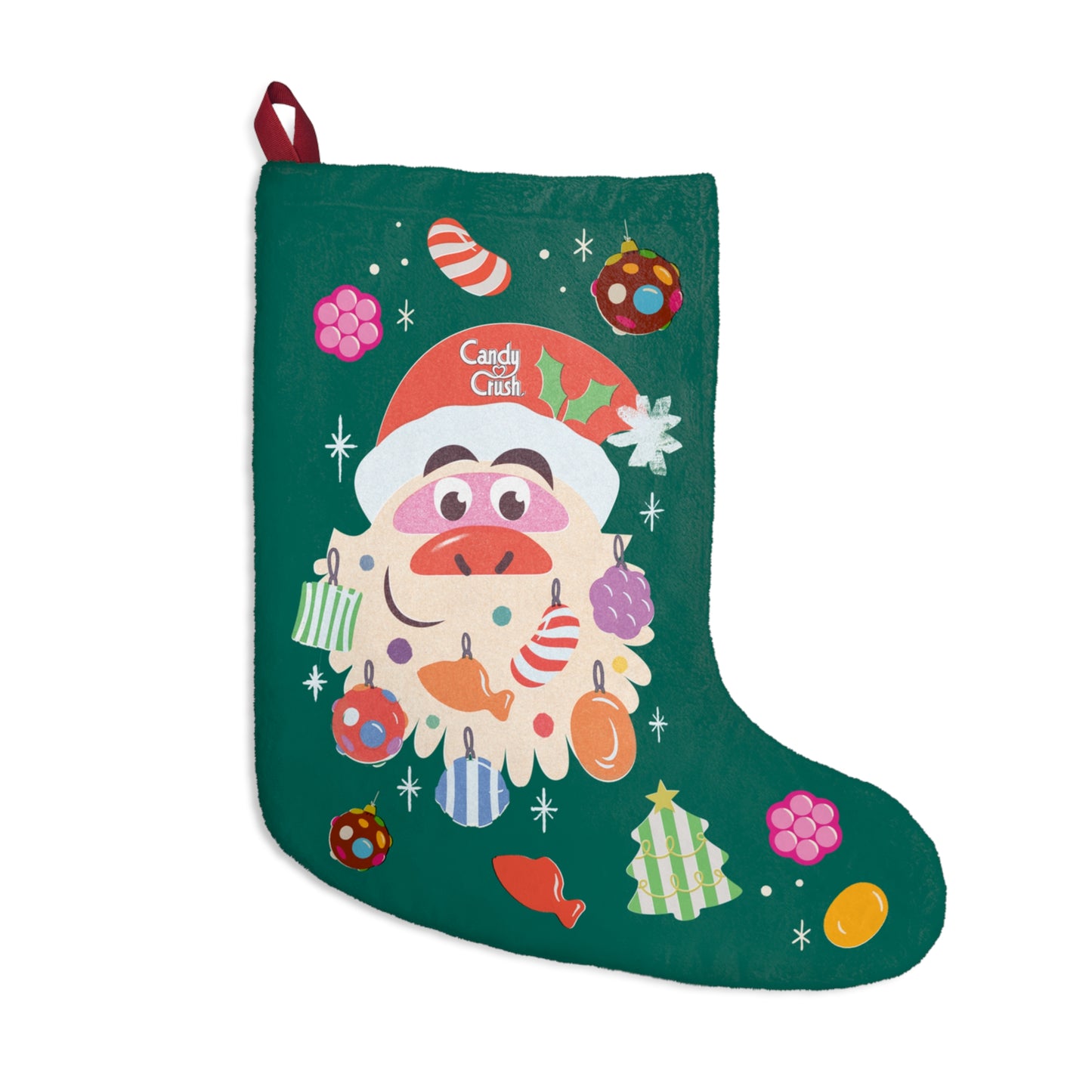 Candy Crush Holiday Stocking hanging on a mantel featuring vibrant pink and blue candy patterns.