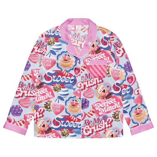 An adult woman wearing a vibrant Candy Crush long sleeve shirt with Be My Crush? printed on the front.
